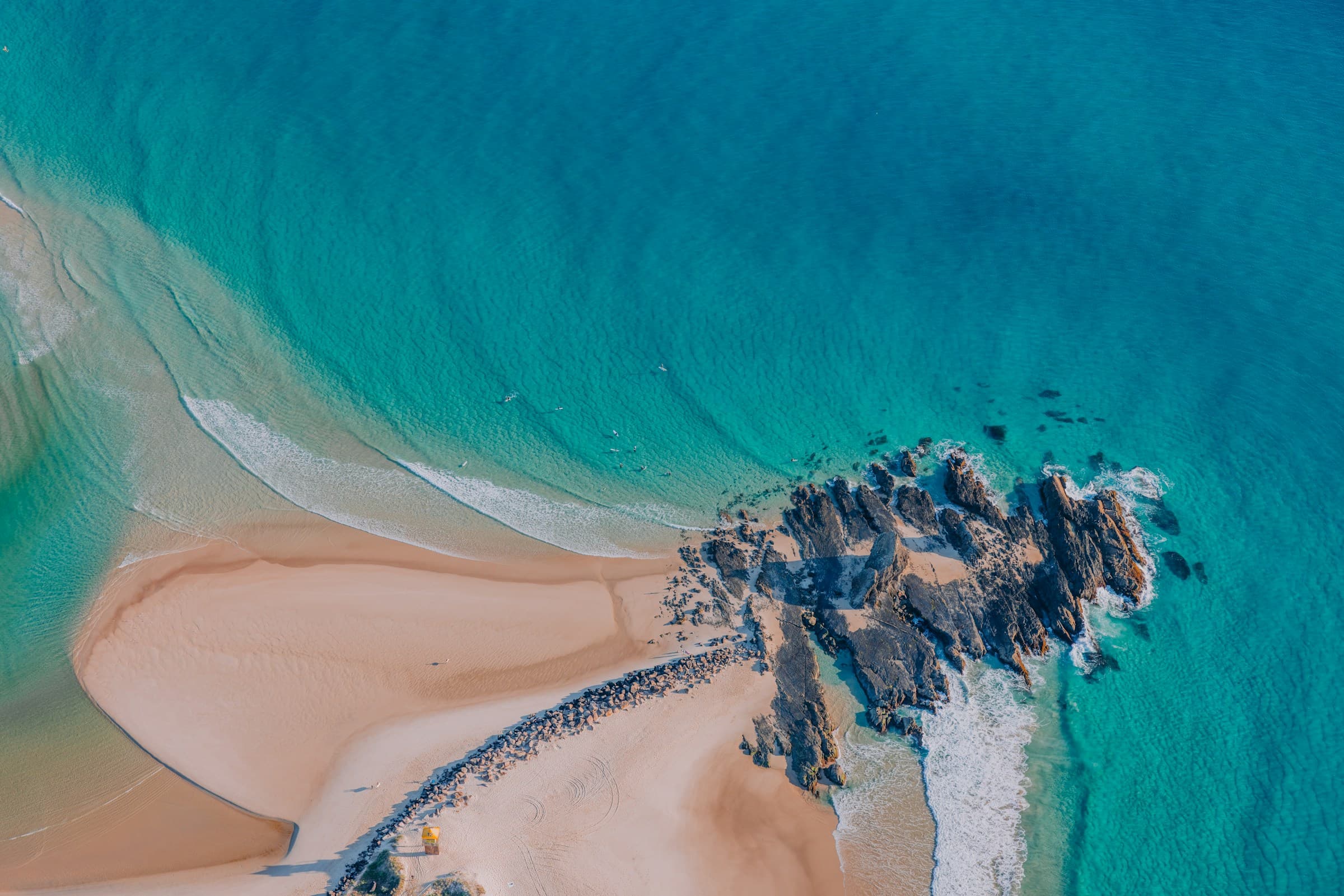 Aerial view of a rocky coastline and turquoise water